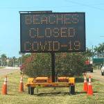 An electronic sign near St. Petersburg, Florida, after beaches in that region were closed over the weekend due to large crowds gathering there. (Dirk Shadd/Tampa Bay Times)