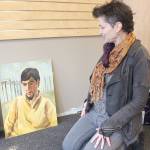 Judith Altruda displays a distinctive portrait by Eugene Landry which features unusual columns in the background. (Photos by Patrick Webb/For The Daily World)