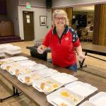 Linda Brummel serves salmon for a Friday night dinner on Easter weekend.