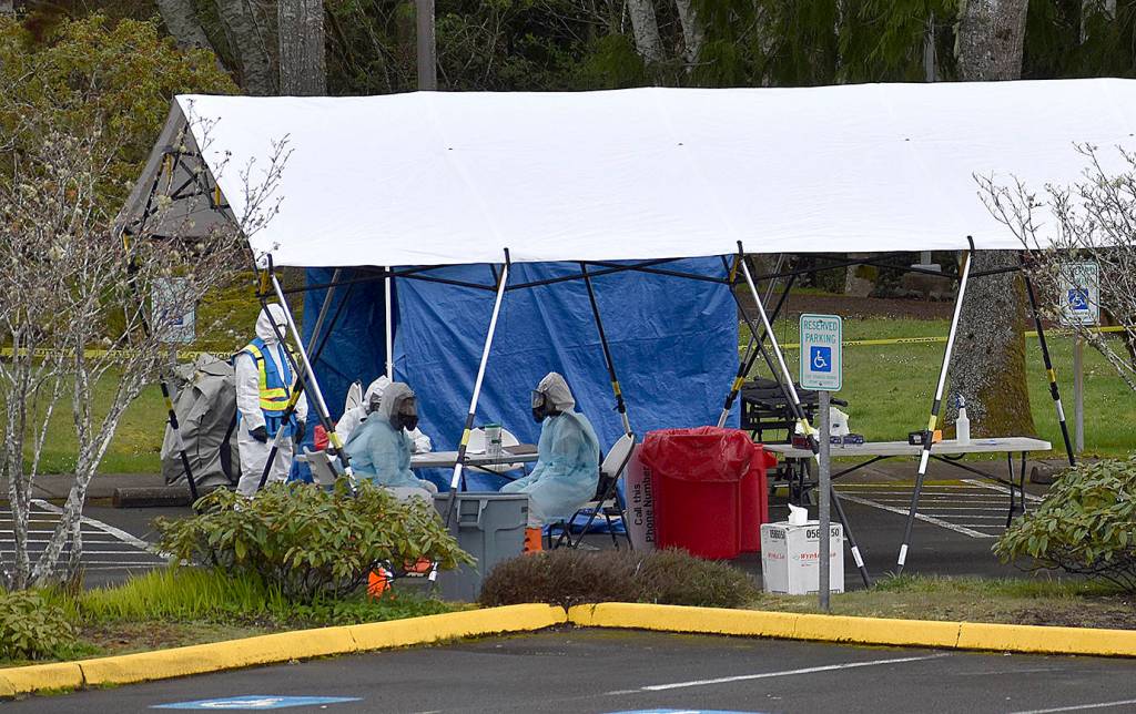 DAN HAMMOCK | GRAYS HARBOR NEWS GROUP                                 Personnel in personal protective gear await the arrival of the 20 people who were scheduled to take COVID-19 tests at the Grays Harbor Public Health drive through test site Wednesday.