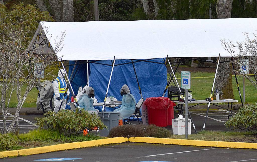 DAN HAMMOCK | GRAYS HARBOR NEWS GROUP                                 Personnel in personal protective gear await the arrival of the 20 people who were scheduled to take COVID-19 tests at the Grays Harbor Public Health drive through test site Wednesday.
