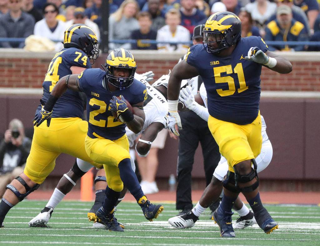 Michigan center Ceasar Ruiz, right, escorts running back Karan Higdon during a 2018 game against Western Michigan. Listed at the NFL Combine at 6-foot-3, 307 pounds, the interior lineman could come off the board on Day 1 of the 2020 draft. (Kirthmon F. Dozier/Detroit Free Press)