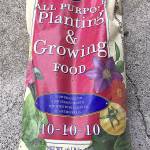 The three numbers on this all-purpose fertilizer bag show the contents comprise equal parts of nitrogen, phosphorus and potassium. This mixture is often used in early spring to promote all-around growth for shrubs and trees. However, for newly planted tomatoes, the better combination would be 5-10-10  not as much nitrogen.