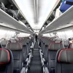 Passengers sit at a distance inside a flight from Miami to Atlanta last week. (Chandan Khanna/Getty Images)