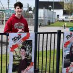 DAN HAMMOCK | GRAYS HARBOR NEWS GROUP                                 Hoquiam High School Class of 2020 honor graduate Kaleb Tarnowski poses with his banner at Art Pocklington Central Play Park Monday morning.