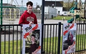 DAN HAMMOCK | GRAYS HARBOR NEWS GROUP                                 Hoquiam High School Class of 2020 honor graduate Kaleb Tarnowski poses with his banner at Art Pocklington Central Play Park Monday morning.