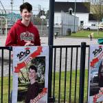 DAN HAMMOCK | GRAYS HARBOR NEWS GROUP                                 Hoquiam High School Class of 2020 honor graduate Kaleb Tarnowski poses with his banner at Art Pocklington Central Play Park Monday morning.