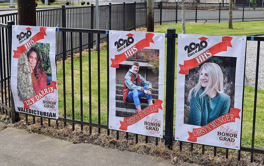 DAN HAMMOCK | GRAYS HARBOR NEWS GROUP                                 The 123 graduating Hoquiam High School seniors are honored with banners, paid for by an anonymous local donor. Monday volunteers were handing out the banners and seniors were able to pose for photos at Art Pocklington Central Play Park.