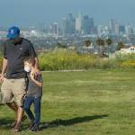 Lee Bloom, 39, of Los Angeles, and his son Evan, 7, wear protective masks against the coronavirus during a visit to Kenneth Hahn State Recreation Area in Los Angeles. (Mel Melcon/Los Angeles Times)