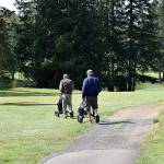 A twosome heads out to play a round of golf at Highland Golf Course in Cosmopolis Tuesday morning.