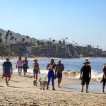 People stroll along Laguna Beach on Tuesday morning as the city, with the states blessings, reopened its beaches for active use only. The first phase of the reopening includes 6-10 a.m. hours Mondays through Fridays. (Irfan Khan/Los Angeles Times)