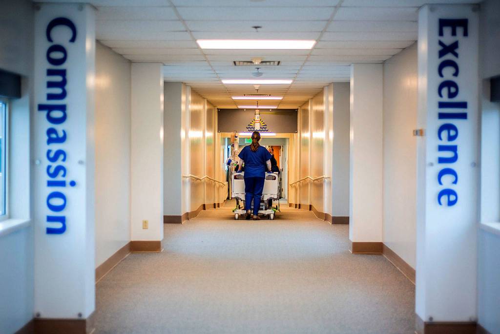 Nurse Trish Cornett wheels a patient through the halls at GHCH.