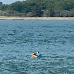 COURTESY PHOTO                                 A Coast Guard rescue swimmer from Sector Columbia River assists a man in the water after his kayak capsized near Ocean Shores May 10. The man was rescued and treated for symptoms related to hypothermia.