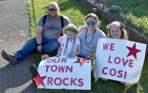 DAN HAMMOCK | GRAYS HARBOR NEWS GROUP                                 Andrea and Michael Franke and their daughters, Ella and Grace, staked out a prime location to catch the parade through Cosmopolis Friday evening. Fire trucks, police and State Patrol vehicles and cars blasted sirens and displayed signs of appreciation for the citys kids and teachers.