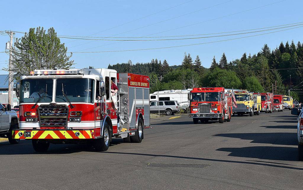DAN HAMMOCK | GRAYS HARBOR NEWS GROUP                                 Emergency vehicles and passenger vehicles paraded through Cosmopolis Friday, honoring the towns families and students during the coronavirus stay-at-home order.