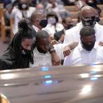 Mourners pause at the casket bearing the remains of George Floyd in the chapel during his funeral service at the Fountain of Praise church Tuesday in Houston, Texas. Floyd died May 25 while in Minneapolis police custody, sparking nationwide protests. (David J. Phillip/Getty Images)