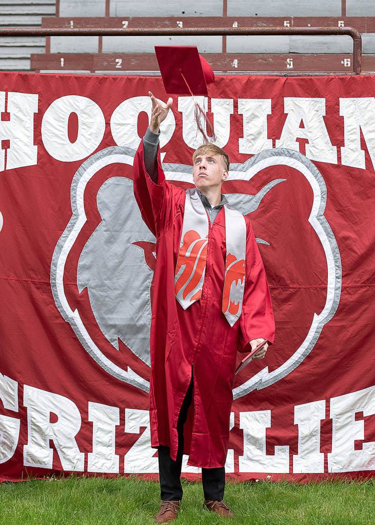 PAMELA PELAN PHOTOGRAPHY                                 Zachary Elsos tosses his graduation cap into the air after picking up his Hoquiam High School diploma at Olympic Stadium ion Monday.