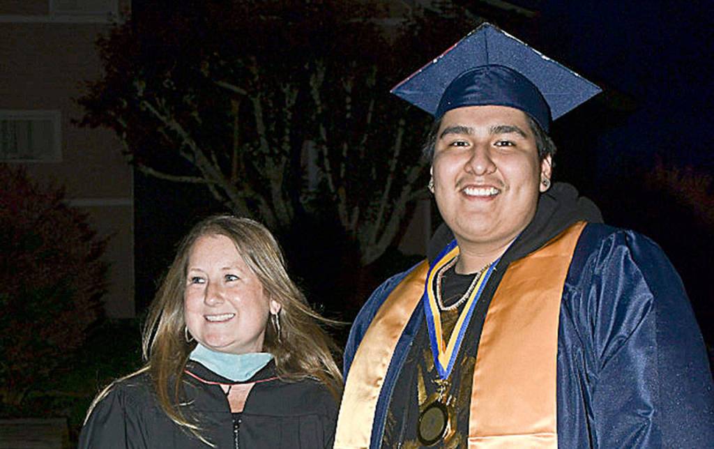 DARRELL WESTMORELAND PHOTO                                 Aberdeen High School counselor Mary Mainio smiles alongside graduating senior Noel Guerrero.