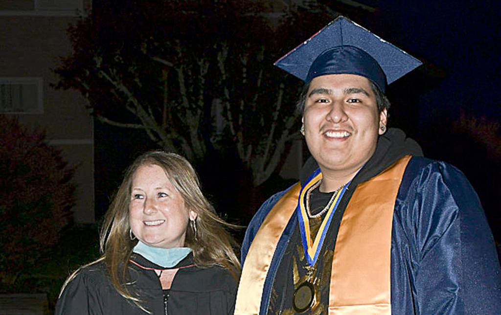 DARRELL WESTMORELAND PHOTO                                 Aberdeen High School counselor Mary Mainio smiles alongside graduating senior Noel Guerrero.
