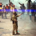 A federal officer points to a protester while clearing the street in front of the Mark O. Hatfield U.S. Courthouse on July 20, 2020 in Portland, Oregon. (Photo by Nathan Howard/Getty Images/TNS)