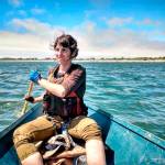 Heather (Margot) Longfellow rows a hand-made, 18-foot plywood dory rowboat in Grays Harbor in late July. (Ryan Hashagen photo)