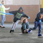 Students play a socially distanced version of Duck Duck Goose as YMCA youth mentor Chayanne Baker, left, looks on during the Harbor After School program on Wednesday at A.J. West Elementary School in Aberdeen. (Ryan Sparks | Grays Harbor News Group)