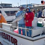 DAN HAMMOCK | GRAYS HARBOR NEWS GROUP                                 Delaney Kramer of Spokane caught this 25-plus-pound Chinook Aug. 13 from the charter boat Predator. Captain Derek Gochanour, holding the salmon, immediately after this photo hustled Kramer and her fish to the Westport Charterboat Association derby booth; it wound up being the daily derby winner.