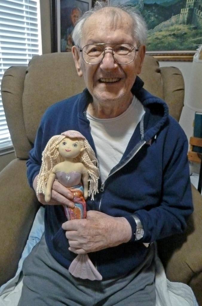 Arnold Samuels holds a mermaid doll he received during his surprise 95th birthday party at the Ocean Shores Senior Center last year. Hes always loved mermaids, said longtime friend Betsy Seidel. (Photo courtesy Betsy Seidel)