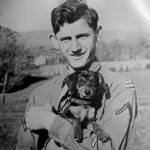 Photo courtesy John Hughes                                Arnold Samuels, wearing a 3rd Infantry Division patch as a private first class, holds a stray dog in Germany.