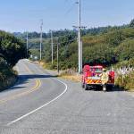 Photo by Stephanie Allestad                                District 8 firefighter/EMT Craig Nohr-Wisner attempts to radio another unit from State Route 109 below the Moclips Grocery. The rural areas topography makes radio communication extremely difficult.