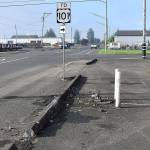 DAN HAMMOCK | THE DAILY WORLDA Volvo took out two light poles on State Street early Wednesday morning before coming to rest in the Daily World employee parking lot.
