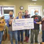 From left, Jamie Judkins, treasurer of Willapa Bay Enterprises Corp; Inge Johnson, PAWS cat coordinator; Linda Francisco, PAWS Board of Directors treasurer; Molle Bouch, PAWS Board of Directors president; Jason Kidwell, PAWS dog coordinator and Valerie Busch, PAWS Board of Directors vice president during the check presentation to PAWS at the Aberdeen shelter on Sept. 25. (Courtesy photo)