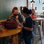Pub Monte co-owner Brooke Hoiness, right, takes an order from a customer on Wednesday in Montesano. (Ryan Sparks | The Daily World)
