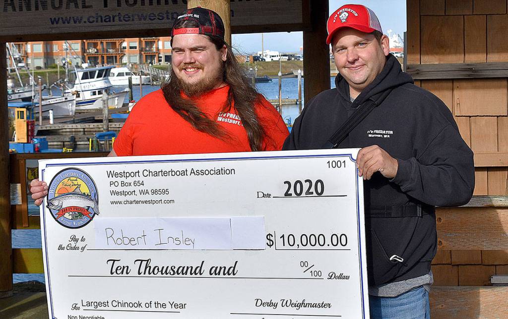 DAN HAMMOCK | THE DAILY WORLD Robert Insley of East Wenatchee, left, picked up his $10,000 check for the largest Chinook weighed in the 2020 Westport Charterboat Association derby Saturday. With him is charterboat Predator captain Derek Gochanour.