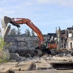 (DAN HAMMOCK | The Daily World)Crews from Rognlins tear down the southeast walls of the Aberdeen Armory building on East Third Street in Aberdeen on Oct. 28, 2019. The building, which burned June 9, 2018, is the former home of the Aberdeen Museum of History.