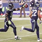 Seattle Seahawks safety Jamal Adams, left, celebrates with teammate Quinton Dunbarafter intercepting a pass on Sept. 20 against the New England Patriots at CenturyLink Field in Seattle. (Abbie Parr/Getty Images)