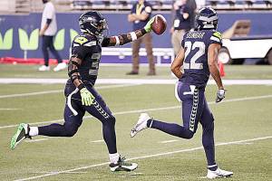Seattle Seahawks safety Jamal Adams, left, celebrates with teammate Quinton Dunbarafter intercepting a pass on Sept. 20 against the New England Patriots at CenturyLink Field in Seattle. (Abbie Parr/Getty Images)
