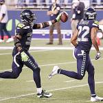 Seattle Seahawks safety Jamal Adams, left, celebrates with teammate Quinton Dunbarafter intercepting a pass on Sept. 20 against the New England Patriots at CenturyLink Field in Seattle. (Abbie Parr/Getty Images)