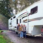 Photo courtesy of Eileen Birdsong Montesano couple John and Janet Workman, pictured here with their neighbor Danny Russell (far left), stand near a fifth-wheel trailer just before donating it to a family in Bridgeport whose home was destroyed by the Pearl Hill Fire in early September.
