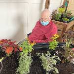 Pacific Care and Rehabilitation Center resident Donald Rouska enjoys the threapeutic garden.