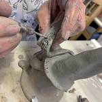 Kat Bryant | The Daily World 
Melanie Knight demonstrates how to fuse two pieces of soft clay together: She roughs it up by cross-hatching the areas that will be joined.