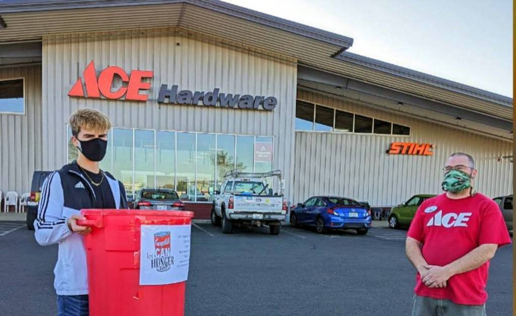 North Beach High School Student Bodie Skinner, left, poses for a photo with Ace Hardware/Buck Electrics Joe Buck during the North Beach High School Food Bowl in December. (Submitted photo)