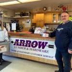 North Beach High School student Katarina Butler, left, and Arrow Lumber representative Ryan Dixon pose for a photo during the schools food bowl drive in December. The North Beach Food Bowl will run through Dec. 10. (Submitted photo)