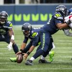 Bettina Hansen/The Seattle Times 
Seattle quarterback Russell Wilson fumbles the snap and the New York Giants recovered in the second quarter on Sunday at Lumen Field in Seattle.
