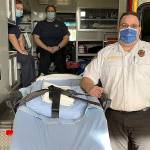South Beach Regional Fire Authority Battalion Chief Daryl Brown stands alongside one of the new power lift gurneys the department was able to purchase with a grant from the federal Assistance to Firefighters grant program.
COURTESY PHOTO