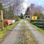 A gate blocks the entrance to the $6 million survival compound in Coupeville on 60 acres. (Andrea Brown / The Herald)