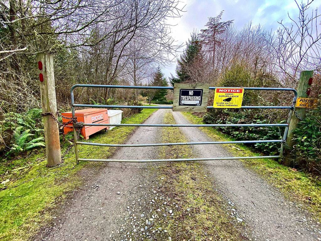 A gate blocks the entrance to the $6 million survival compound in Coupeville on 60 acres. (Andrea Brown / The Herald)