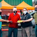 COURTESY PHOTO 
The Hoquiam elementary administrative team hands Joe Cornell a donation for his organization, Making a Difference for Grays Harbor Kids. Pictured from left are Brandon Winkelman, Cornell, Laurie Gordon, and Kent Nixon.