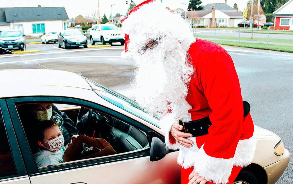 Kailyn Jackson and Sara Zillyette with Santa at Emerson Elementarys drive through Santa event Tuesday. COURTESY PHOTO