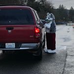 Santa Husky hands out treats at Stevens Elementary School. Over 150 students came for the social distance drive-by Santa Husky and his helpers.